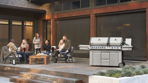 backyard party with patio furniture and a grill