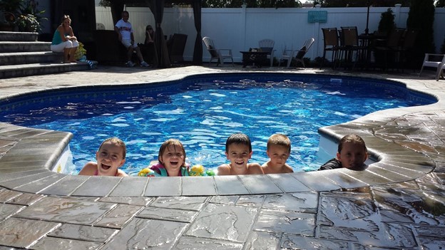 Want to know how to create the coolest backyard every? Try adding a pool to your backyard, like this Radiant inground pool these children are playing in.